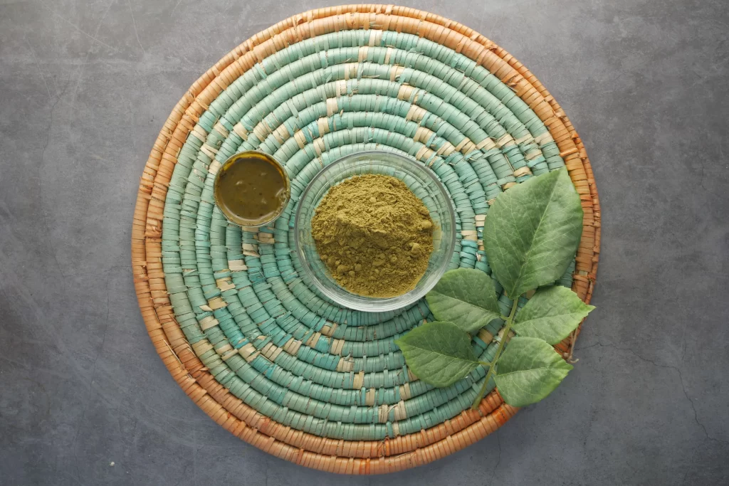 wooden bowl with rehydrated henna on table